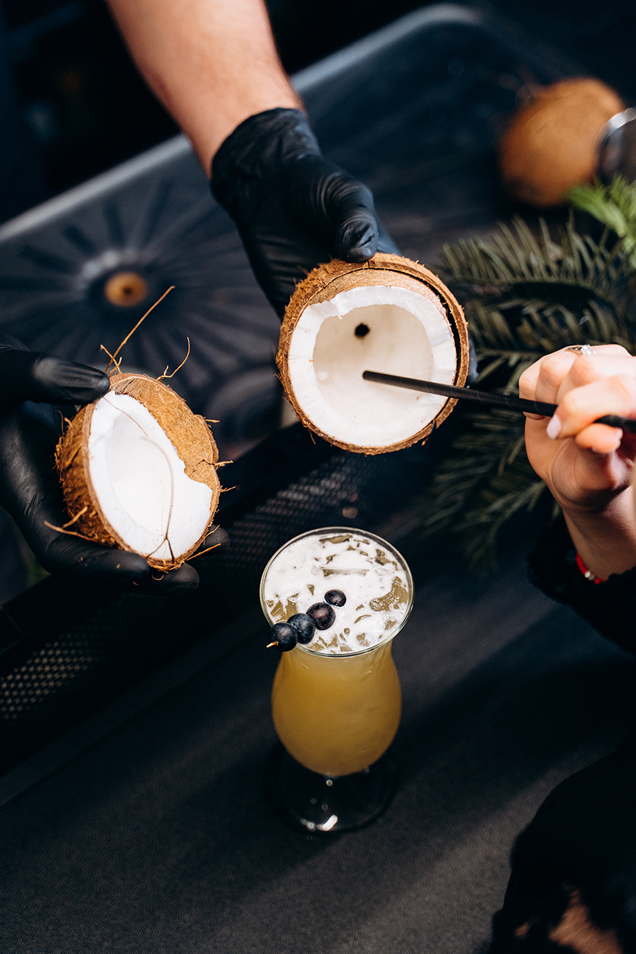 Olympvs Lounge & Bar drinking from a coconut and pina colada cocktail